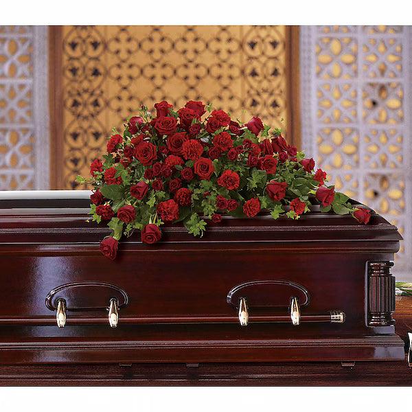 Red roses on a wooden casket with a decorative background