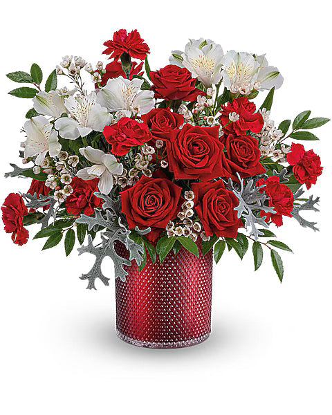 Bouquet of red and white flowers in a red vase