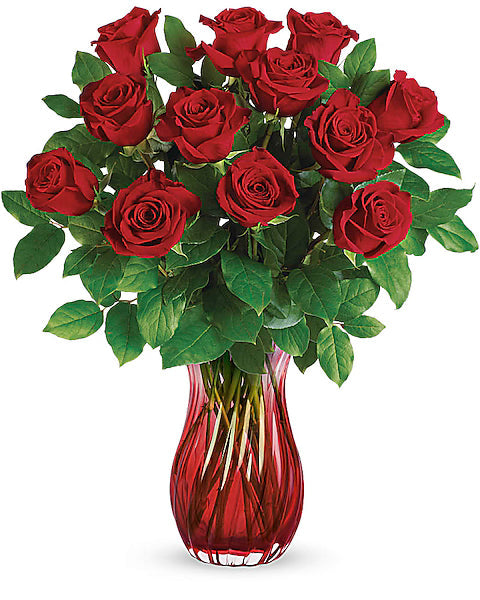 Fresh red roses in a glossy red vase