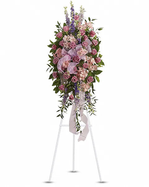 Elegant pink and purple flower display on stand with ribbons