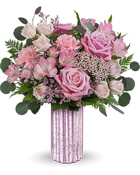 Bouquet of pink flowers in a decorative vase on a white background