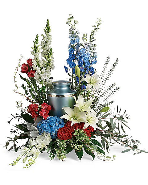 Blue urn adorned with vibrant flowers on plain white background