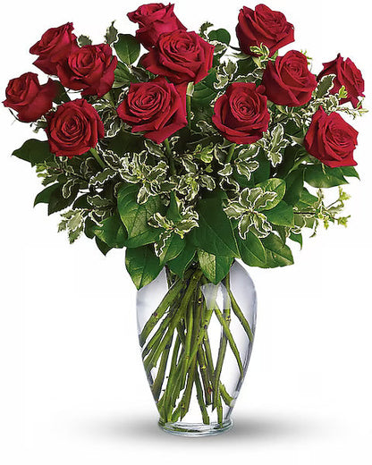 Bouquet of red roses in a clear vase on a white background