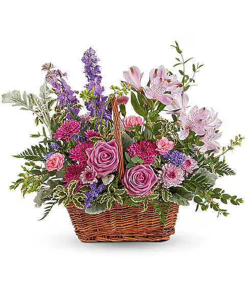Floral arrangement in a wicker basket on a white background
