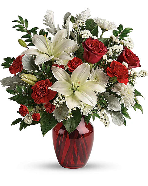 Bouquet of red and white flowers in a red vase on a white background